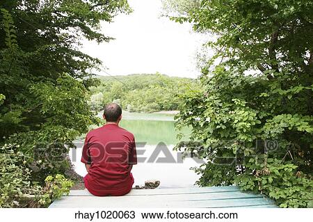 Men relaxing on lake View Large Photo Image Stock Image - Men relaxing on lake. Fotosearch