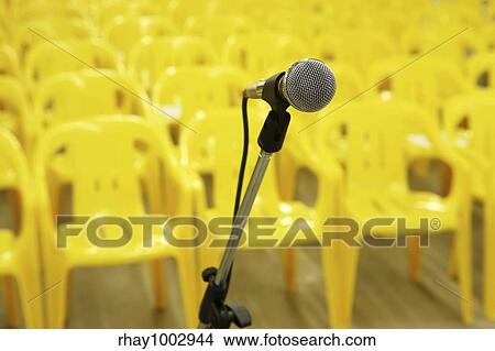 Picture - Microphone against yellow chairs. Fotosearch