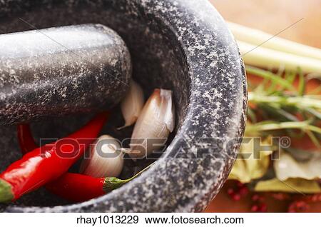 Stock Photo - "Mortar with thai spices (garlic, chili, pepper, lemon grass)". Fotosearch