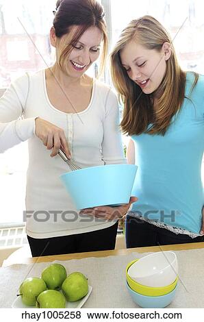 Mother and daughter cooking together at home View Large Photo Image Stock Photo - Mother and daughter cooking together at home. Fotosearch