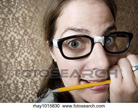 Nervous nerdy Woman Chewing on a Yellow Pencil View Large Photo Image Stock Image - Nervous nerdy Woman Chewing on a Yellow Pencil. Fotosearch