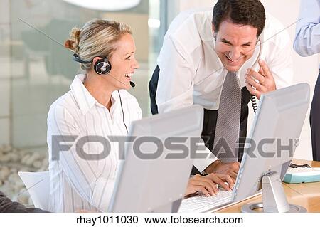 Stock Image - office scene with telephonist. Fotosearch