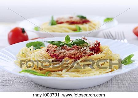 Pasta with tomato sauce basil and grated parmesan View Large Photo Image Stock Image - Pasta with tomato sauce basil and grated parmesan. Fotosearch