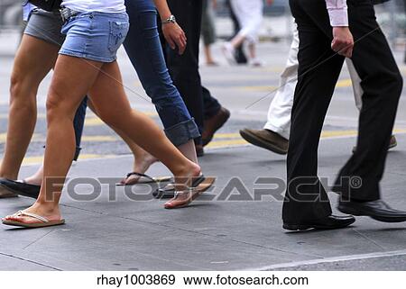 People walking on a busy street in the city center View Large Photo Image Stock Photo - People walking on a busy street in the city center. Fotosearch