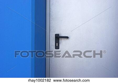 Stock Image - Picture of a door in a modern building with blue walls. Fotosearch