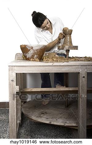 Picture of a potter works on a wood potter's wheel View Large Photo Image Stock Photograph - Picture of a potter works on a wood potter's wheel. Fotosearch