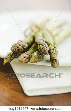 Pile of asparagus on the kitchen table View Large Photo Image Stock Photo - Pile of asparagus on the kitchen table. Fotosearch