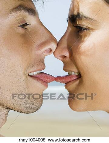 Portait of a young couple giving a tonge kiss View Large Photo Image Stock Photo - Portait of a young couple giving a tonge kiss. Fotosearch