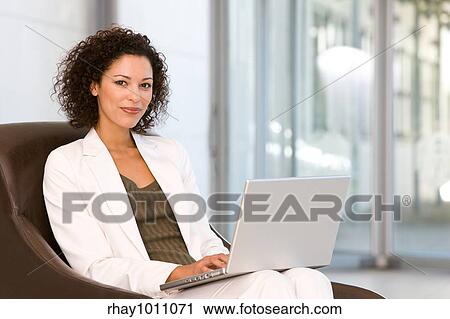 portrait of a business woman sitting with laptop View Large Photo Image Stock Image - portrait of a business woman sitting with laptop. Fotosearch