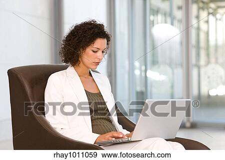 portrait of a business woman sitting with laptop View Large Photo Image Stock Photo - portrait of a business woman sitting with laptop. Fotosearch