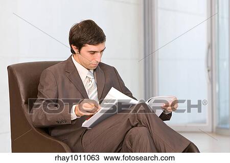 Stock Image - portrait of a businessman sitting with laptop. Fotosearch