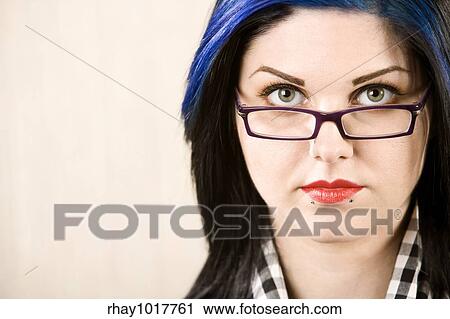 Portrait of a cute rockabilly woman looking over her glasses View Large Photo Image Stock Image - Portrait of a cute rockabilly woman looking over her glasses. Fotosearch