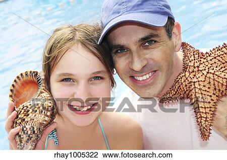 Stock Image - Portrait of a family enjoying tropical vacation. Fotosearch