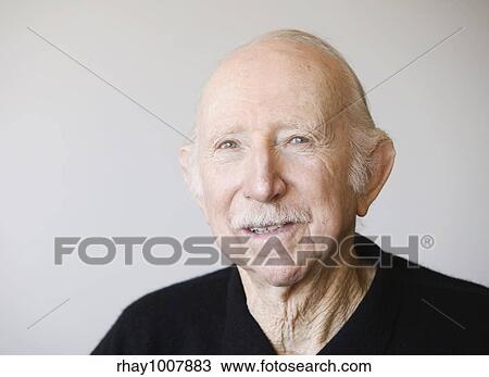 Stock Image - Portrait of a male senior citizen against a white background.. Fotosearch
