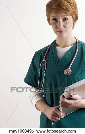 Stock Photography - Portrait of female medical personnel wearing scrubs and stethoscope. Fotosearch