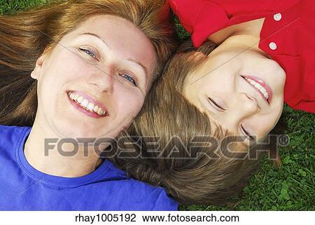 Portrait of smiling mother and son in summer park View Large Photo Image Stock Image - Portrait of smiling mother and son in summer park. Fotosearch