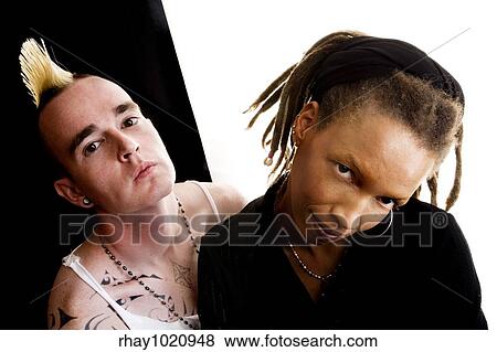 Stock Photo - Portrait of white man with mohawk and black woman with dreadlocks. Fotosearch