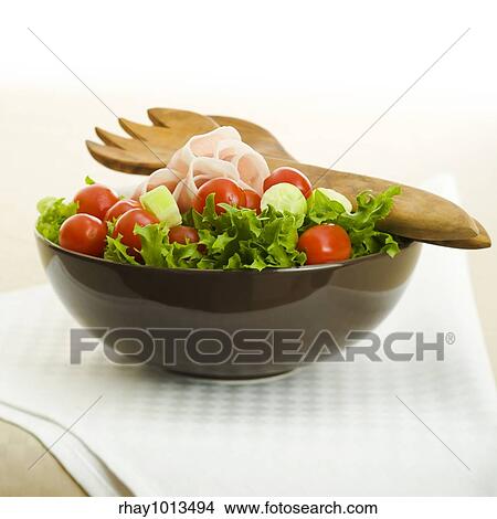 Picture - Prosciutto salad with wooden spoon on the table. Fotosearch