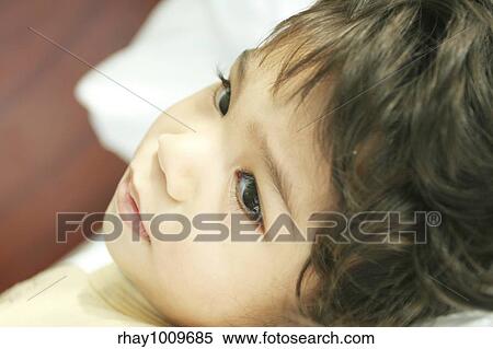 "Quiet time of rest for this tired little boy. Part asian, scandinavian descent. " View Large Photo Image Stock Photography - "Quiet time of rest for this tired little boy. Part asian, scandinavian descent. ". Fotosearch