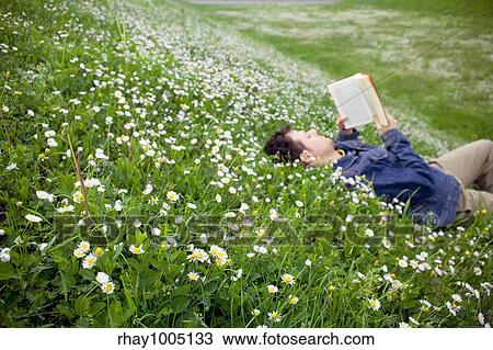 reading in the grass View Large Photo Image Stock Image - reading in the grass. Fotosearch