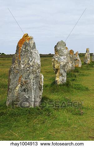 Stock Image - "Row of prehistoric megalithic monuments menhirs in Brittany, France". Fotosearch