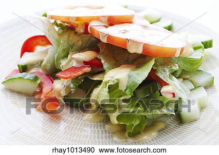 Salad on the plate with dressing View Large Photo Image Stock Image - Salad on the plate with dressing. Fotosearch