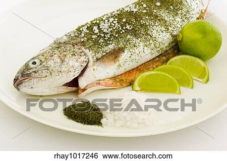 Stock Photograph - "Salmon prepared for warm smoking on the plate with dill, sea salt and lime". Fotosearch