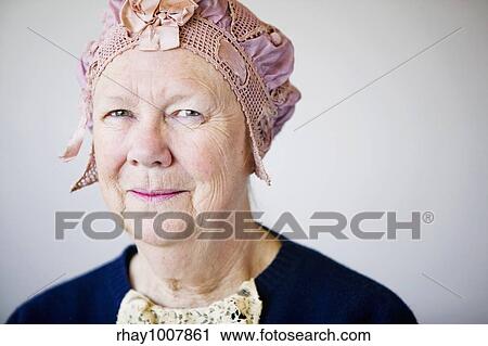 Senior smiling woman in the studio wearing a vintage hat and lace. View Large Photo Image Stock Image - Senior smiling woman in the studio wearing a vintage hat and lace.. Fotosearch