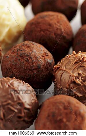 Stock Photo - Several assorted gourmet chocolate truffles close up. Fotosearch