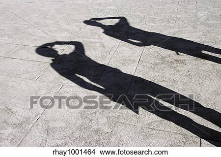 Shadows on a marble surface of two people scouting for something. View Large Photo Image Picture - Shadows on a marble surface of two people scouting for something.. Fotosearch
