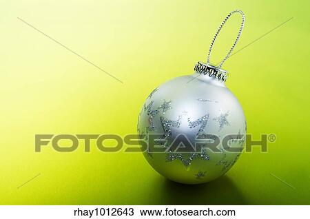 Silver Christmas bulb sitting on a green background. View Large Photo Image Stock Image - Silver Christmas bulb sitting on a green background.. Fotosearch