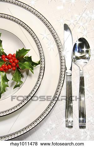 Stock Photo - Silver plate setting with a sprig of holly and stars. Fotosearch