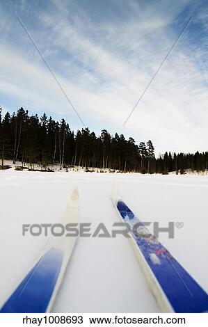 Stock Image - Skiing on a bright sunny day. Fotosearch