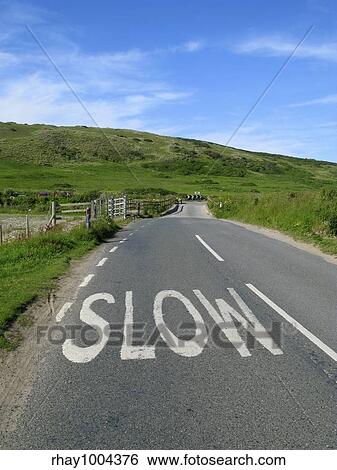 Slow sign on an English countryside road. View Large Photo Image Stock Photograph - Slow sign on an English countryside road.. Fotosearch