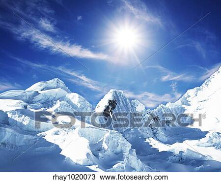 Stock Image - Snow-covered high mountain. Fotosearch