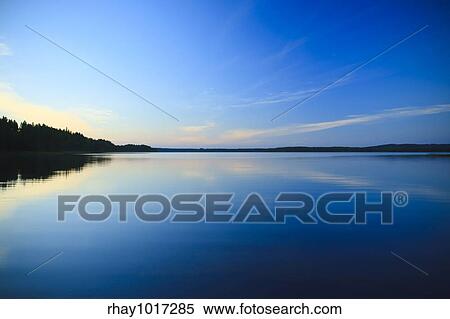 sunset on lake with sky reflections on the water View Large Photo Image Stock Photography - sunset on lake with sky reflections on the water. Fotosearch
