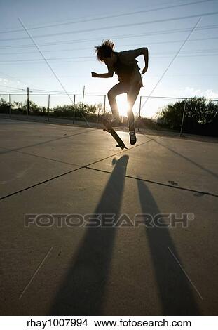 Teenage boy skateboarder with his board. View Large Photo Image Picture - Teenage boy skateboarder with his board.. Fotosearch