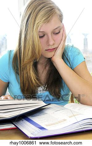 Teenage girl studying with textbooks looking unhappy View Large Photo Image Stock Image - Teenage girl studying with textbooks looking unhappy. Fotosearch