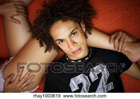 teenager resting by woman's legs View Large Photo Image Stock Photo - teenager resting by woman's legs . Fotosearch