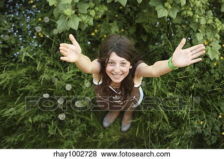 The girl with a happy smile on a green grass The girl with a happy smile on a green grass View Large Photo Image Stock Photo - The girl with a happy smile on a green grass The girl with a happy smile on a green grass . Fotosearch