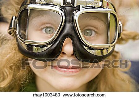 The ridiculous little girl with long hair and grey eyes in motorcycle glasses close upThe ridiculous little girl with long hair and grey eyes in motorcycle glasses close up View Large Photo Image Stock Image - The ridiculous little girl with long hair and grey eyes in motorcycle glasses close upThe ridiculous little girl with long hair and grey eyes in motorcycle glasses close up. Fotosearch