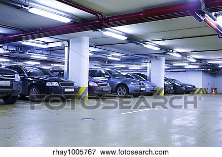 The shined underground garage with the moving cars and parked carsThe shined underground garage with the moving cars and parked cars View Large Photo Image Stock Photo - The shined underground garage with the moving cars and parked carsThe shined underground garage with the moving cars and parked cars. Fotosearch
