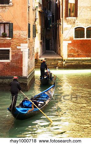 Stock Photo - tourist attractions: Venice at the sunset. The focus is on the left wall while Gondolas are slightly blurred. Fotosearch