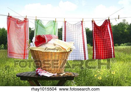 Towels drying on the clothesline with laundry basket View Large Photo Image Picture - Towels drying on the clothesline with laundry basket. Fotosearch
