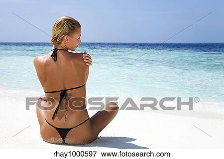 tropical beach: perfect girl meditating on a tropical beach. Copy space View Large Photo Image Stock Photo - tropical beach: perfect girl meditating on a tropical beach. Copy space. Fotosearch