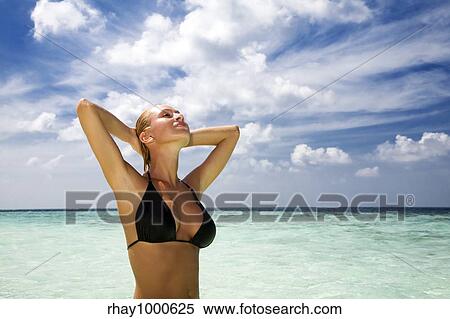 Stock Photography - tropical beach: perfect girl meditating on a tropical beach. Copy space. Fotosearch