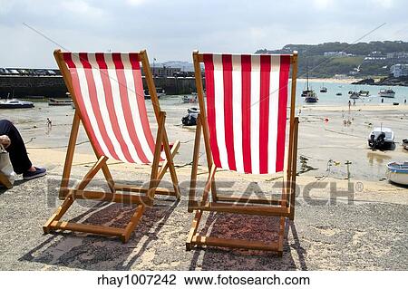 Stock Image - "Two empty deckchairs on the sea front, St. Ives, UK. ". Fotosearch