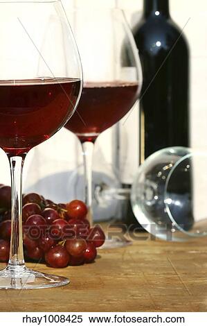 Two glasses of red wine on a table View Large Photo Image Stock Photography - Two glasses of red wine on a table. Fotosearch