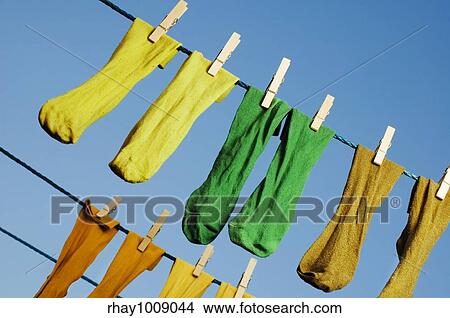 Picture - washed socks hanging on a rope outside. Fotosearch