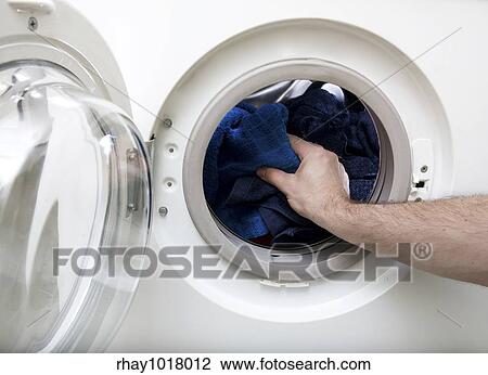 Washing clothes in a front loading washer View Large Photo Image Stock Image - Washing clothes in a front loading washer. Fotosearch